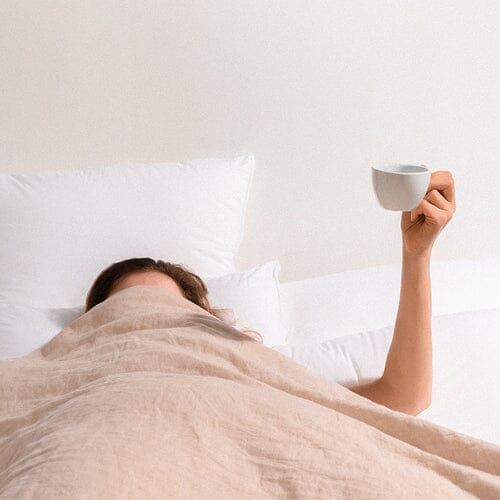 Woman laying in bed happy with pillow helping Neck pain